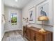 Bright entryway featuring a stylish wooden console table, decor, and view through a glass-paneled front door at 743 Plumage Ct., Myrtle Beach, SC 29588