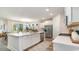 Open-concept kitchen featuring a large island with quartz countertops, stainless steel appliances and hardwood floors at 743 Plumage Ct., Myrtle Beach, SC 29588