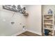 Functional laundry room featuring built-in shelving and hardwood floors at 743 Plumage Ct., Myrtle Beach, SC 29588