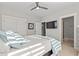 Bedroom with white bedspread, mounted tv, ceiling fan, and multiple doors at 808 Crescent Sable Ct., Myrtle Beach, SC 29572