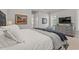 Bright main bedroom with a white linens, grey dresser, and television set at 808 Crescent Sable Ct., Myrtle Beach, SC 29572