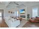 Open-concept living room with fireplace, coffered ceilings, and large windows, providing ample natural light at 848 Crystal Water Way, Myrtle Beach, SC 29579