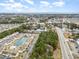 Stunning aerial view of a residential community featuring a pool, pond, and proximity to the beach and shopping areas at 8538 Hopkins Circle # E, Surfside Beach, SC 29575