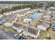 Aerial view of a complex with a pool and lake at 8538 Hopkins Circle # E, Surfside Beach, SC 29575