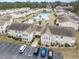 Aerial view of a community featuring a serene pond and swimming pool at 8538 Hopkins Circle # E, Surfside Beach, SC 29575