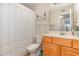 Cozy bathroom featuring a mirrored cabinet and a dragonfly patterned shower curtain at 8538 Hopkins Circle # E, Surfside Beach, SC 29575