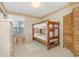 Cozy bedroom with bunk beds, neutral walls, and a decorative rug at 8538 Hopkins Circle # E, Surfside Beach, SC 29575