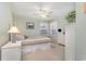 Serene bedroom featuring soft green walls, a comfortable bed, and natural light from a large window at 8538 Hopkins Circle # E, Surfside Beach, SC 29575