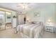 Light-filled bedroom with a comfortable bed, large mirror, and fresh green walls at 8538 Hopkins Circle # E, Surfside Beach, SC 29575