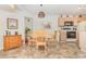 Charming dining area with a round wooden table, four chairs, and tiled floors under a unique light fixture at 8538 Hopkins Circle # E, Surfside Beach, SC 29575
