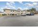 Condominium exterior featuring well-maintained landscaping and ample parking at 8538 Hopkins Circle # E, Surfside Beach, SC 29575