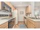 Functional kitchen featuring light wood cabinetry, essential appliances, and tile flooring for easy maintenance at 8538 Hopkins Circle # E, Surfside Beach, SC 29575