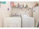 Practical laundry room with a washer and dryer and shelving for storage at 8538 Hopkins Circle # E, Surfside Beach, SC 29575