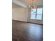 Open dining area with hardwood floors, large window, and elegant chandelier at 8639 Farrier Dr., Myrtle Beach, SC 29588