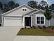 Charming single-story home showcasing a well-manicured lawn and attached two-car garage at 8639 Farrier Dr., Myrtle Beach, SC 29588