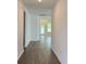 Inviting hallway featuring hardwood floors and white walls leading to a bright living space at 8639 Farrier Dr., Myrtle Beach, SC 29588
