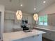Modern kitchen island featuring quartz countertops, pendant lights, and stainless appliances at 8639 Farrier Dr., Myrtle Beach, SC 29588