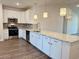 Bright, modern kitchen with white cabinets, stainless steel appliances, and granite countertops at 8643 Farrier Dr., Myrtle Beach, SC 29588