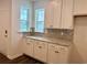 Elegant kitchen featuring stylish backsplash, granite counters, and white cabinets with ample storage at 8643 Farrier Dr., Myrtle Beach, SC 29588