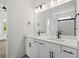 Bathroom with dual sink vanity, quartz countertop, matte black fixtures, and large mirror at 885 Bear Lake Dr., Longs, SC 29568