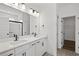 Bright bathroom featuring double sink vanity, sleek black fixtures, and glass enclosed shower at 885 Bear Lake Dr., Longs, SC 29568