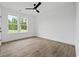 Bright bedroom with wood floors, ceiling fan, and double hung windows at 885 Bear Lake Dr., Longs, SC 29568