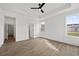 Spacious bedroom with tray ceiling, fan, wood-look floors, and multiple windows at 885 Bear Lake Dr., Longs, SC 29568