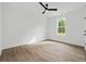 Bright bedroom featuring wood floors, a ceiling fan, and a bright window view at 885 Bear Lake Dr., Longs, SC 29568