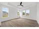 Bright bedroom features wood-look floors, a ceiling fan, and multiple windows for natural light at 885 Bear Lake Dr., Longs, SC 29568