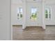 Bright foyer showcasing the front door and hardwood floors at 885 Bear Lake Dr., Longs, SC 29568