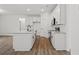 Modern kitchen with white cabinets, gray countertops and a kitchen island with sink at 885 Bear Lake Dr., Longs, SC 29568