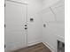 Well-lit laundry area includes washer hookups, wall-mounted shelf and a sleek door at 885 Bear Lake Dr., Longs, SC 29568