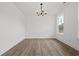 Spacious living room with hardwood floors and ample natural light from the windows at 885 Bear Lake Dr., Longs, SC 29568