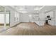 Spacious living area featuring recessed lights, abundant windows, and wood-look flooring at 885 Bear Lake Dr., Longs, SC 29568