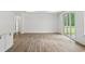 Bright, open living room with wood-look floors and a sliding glass door to outdoor space at 885 Bear Lake Dr., Longs, SC 29568