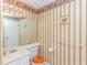 Bathroom with white vanity, toilet, and decorative wallpaper at 914 Hillside Dr. S # O, North Myrtle Beach, SC 29582