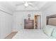 Bright bedroom features a ceiling fan, closet, and dresser at 914 Hillside Dr. S # O, North Myrtle Beach, SC 29582