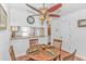 Cozy dining area with a round wood table, seating for four, and a decorative ceiling fan with light fixture at 914 Hillside Dr. S # O, North Myrtle Beach, SC 29582