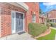 Close-up view of the front entrance featuring a decorative door and well-maintained landscaping at 914 Hillside Dr. S # O, North Myrtle Beach, SC 29582