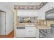 Kitchen with a view into living area featuring a stainless steel dishwasher, sink and appliances at 914 Hillside Dr. S # O, North Myrtle Beach, SC 29582