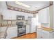 Cozy kitchen with white cabinetry, tile countertops and stainless steel appliances at 914 Hillside Dr. S # O, North Myrtle Beach, SC 29582