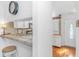 Kitchen and entry featuring white cabinets, tile countertops and access to the main door at 914 Hillside Dr. S # O, North Myrtle Beach, SC 29582