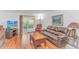 Bright living room with hardwood floors, sliding glass doors to the patio, and comfortable leather seating at 914 Hillside Dr. S # O, North Myrtle Beach, SC 29582