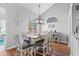 Cozy dining area with a stylish light fixture, a wooden table, and large windows providing natural light at 9430 Pinckney Ln., Murrells Inlet, SC 29576