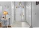 Inviting foyer with tile flooring, a decorative light fixture, and a white front door with sidelights at 9430 Pinckney Ln., Murrells Inlet, SC 29576