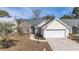 Charming single-Gathering home with well-maintained lawn, brick accents, and an attached two-car garage at 9430 Pinckney Ln., Murrells Inlet, SC 29576