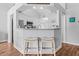Eat-in kitchen with gray cabinets, stainless appliances, modern pendant lighting and seating at bar at 9430 Pinckney Ln., Murrells Inlet, SC 29576