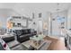 Comfortable living room featuring leather seating, a vaulted ceiling, and natural light from the front entrance at 9430 Pinckney Ln., Murrells Inlet, SC 29576