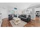 Bright living room with hardwood flooring, comfortable seating, and an open layout leading to the dining area at 9430 Pinckney Ln., Murrells Inlet, SC 29576