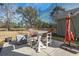 Inviting outdoor patio with a dining set perfect for enjoying golf course views and outdoor meals at 9430 Pinckney Ln., Murrells Inlet, SC 29576